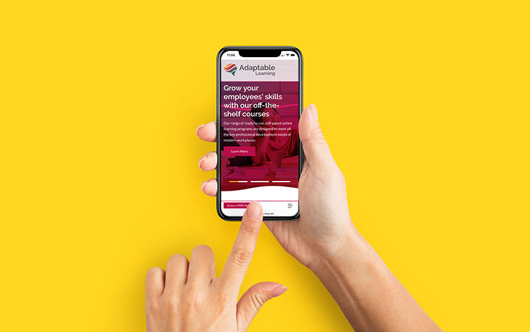 Hands holding a mobile phone with a custom website design displayed on it