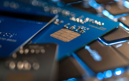 close up photo of credit cards stacked on a computer keyboard