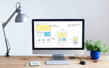 Computer screen with graphics of wireframe web design