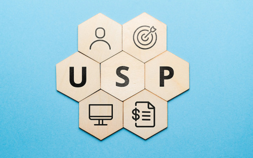 cronym USP or Unique Selling Proposition. Abstract icons and text on wooden forms