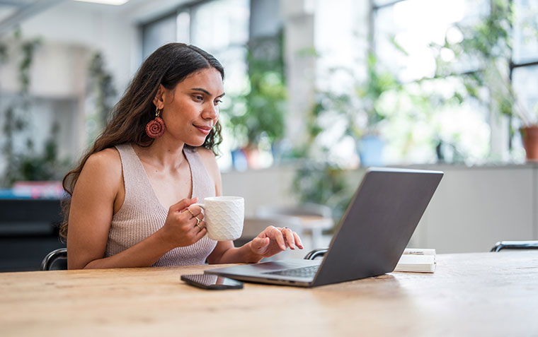 Confident Young Aboriginal Businesswoman Engaged on Laptop